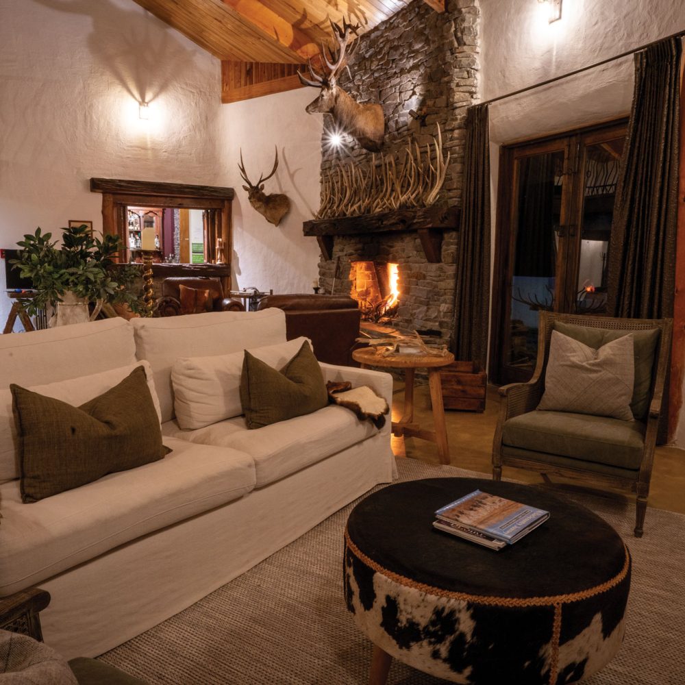 Kuranui Lodge's grand stone fireplace in the main living area.