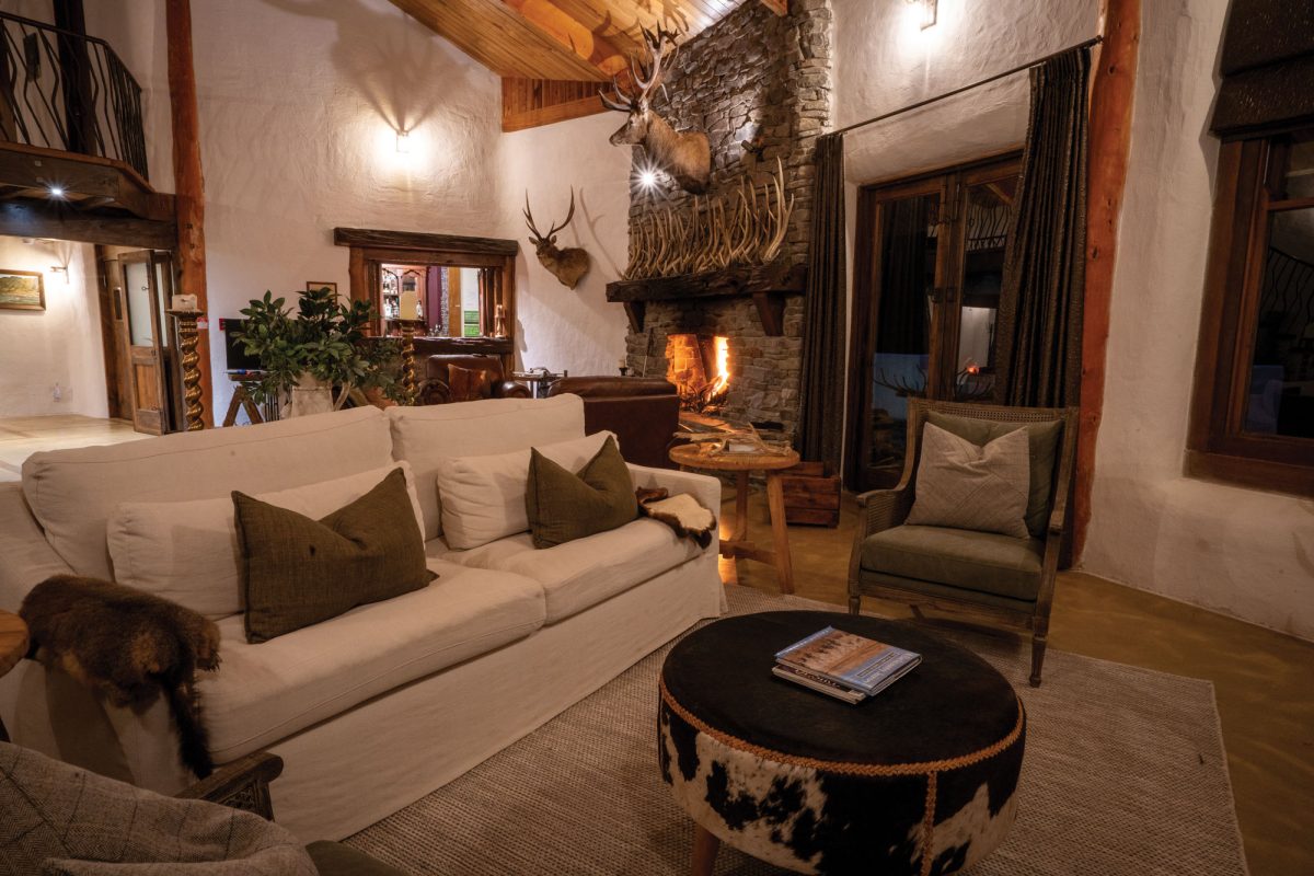 Kuranui Lodge's grand stone fireplace in the main living area.