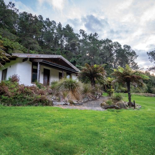 Exterior view of Kuranui Private Villas amidst natural surroundings.